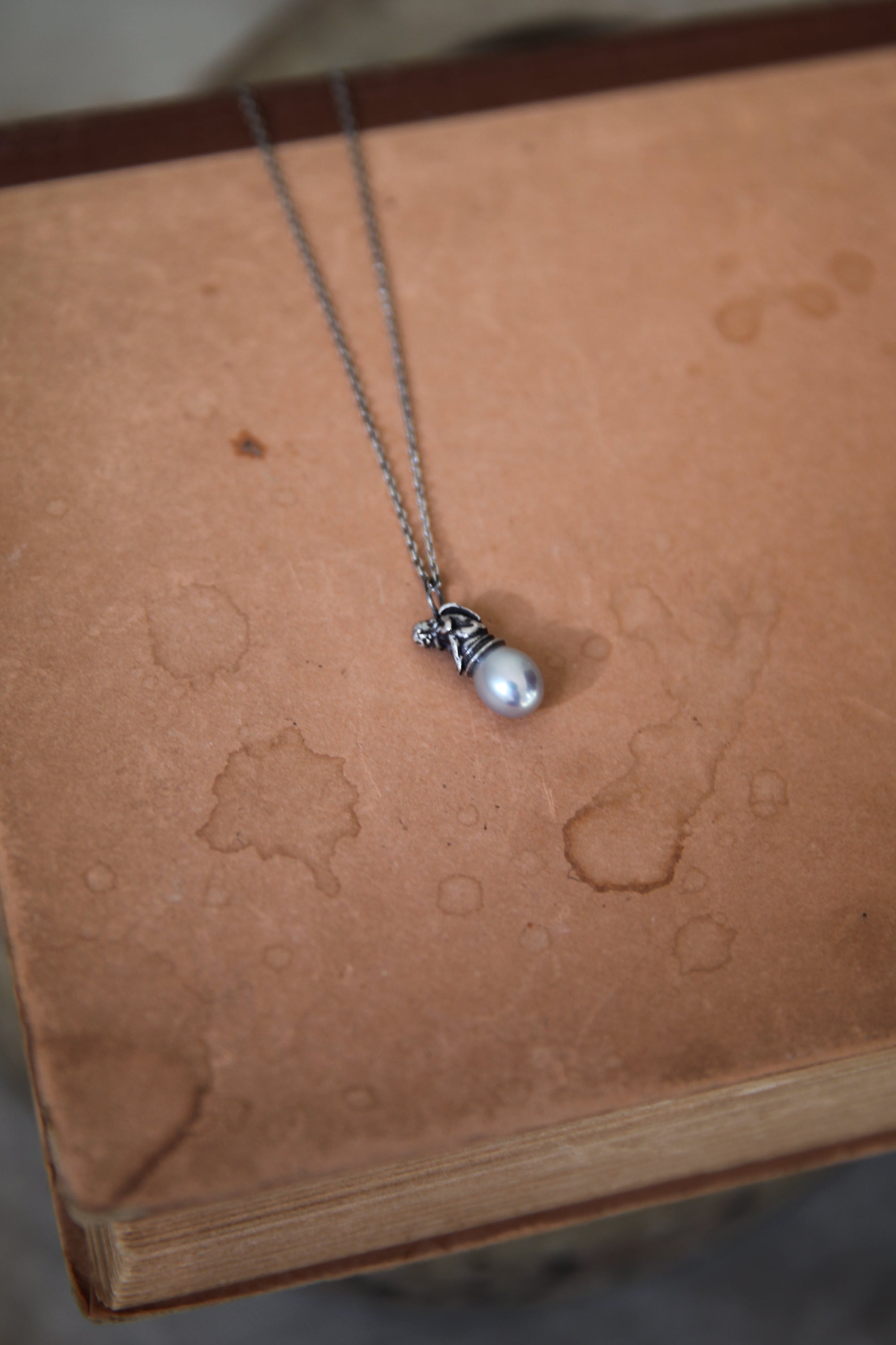 Cherub on a Pearl Necklace